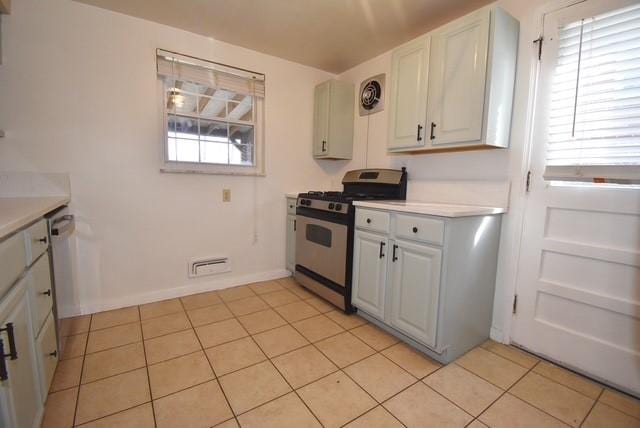 kitchen featuring light tile patterned floors, visible vents, white cabinets, appliances with stainless steel finishes, and light countertops