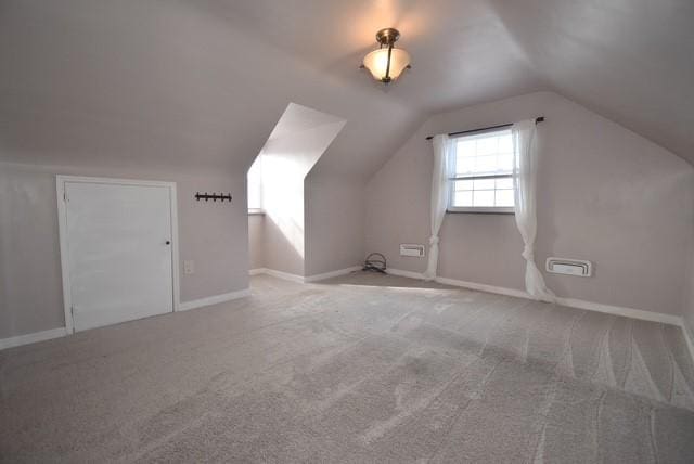 bonus room featuring vaulted ceiling, carpet floors, and baseboards