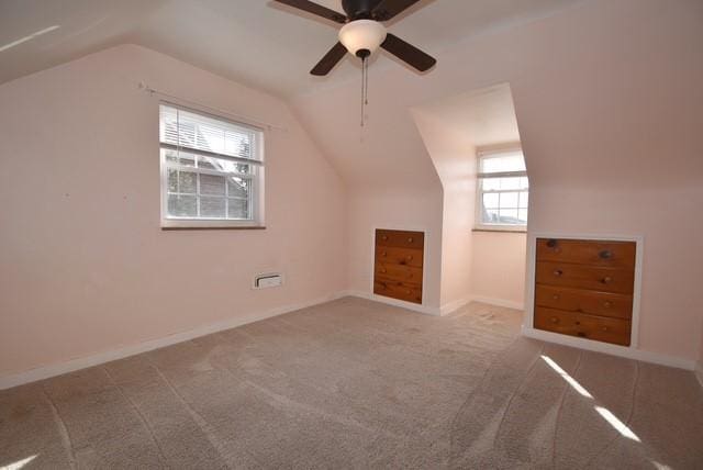 additional living space with vaulted ceiling, ceiling fan, carpet flooring, and baseboards