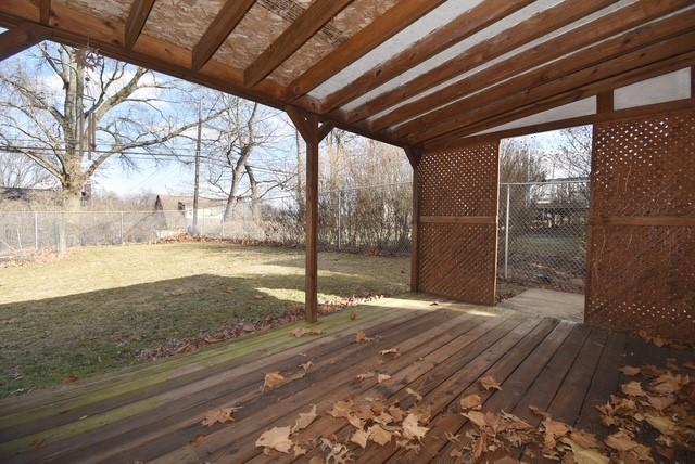 deck featuring a lawn and a fenced backyard