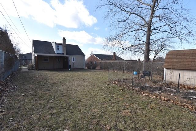 view of yard with a fenced backyard and an outbuilding