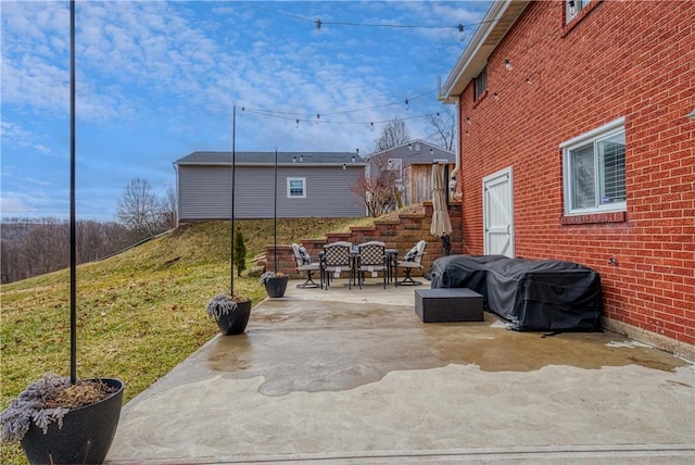 view of patio with outdoor dining space and a grill