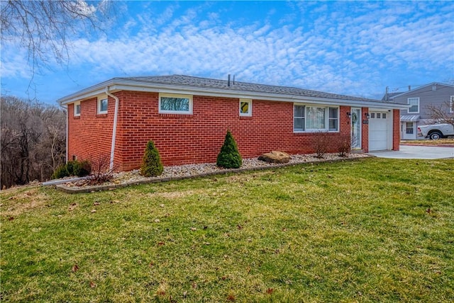 view of front of property featuring concrete driveway, brick siding, an attached garage, and a front lawn