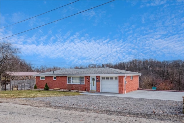 single story home featuring a garage, driveway, fence, and brick siding