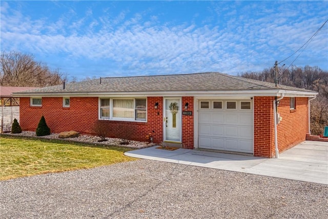 ranch-style home with aphalt driveway, brick siding, a shingled roof, an attached garage, and a front lawn