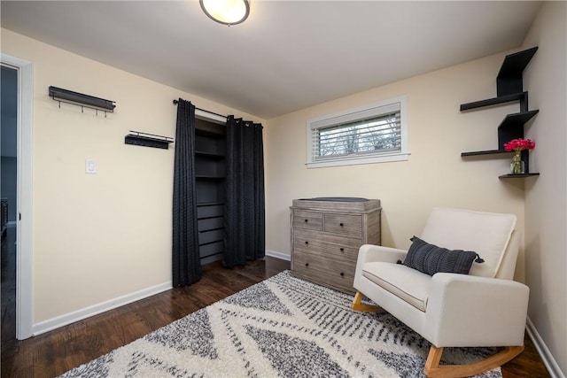 living area featuring baseboards and wood finished floors