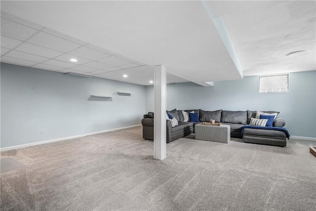 living area featuring carpet, a drop ceiling, baseboards, and recessed lighting