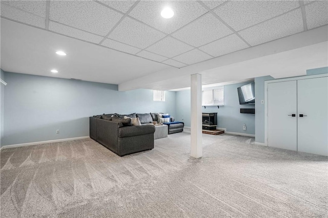 living area featuring a drop ceiling, carpet, recessed lighting, and baseboards