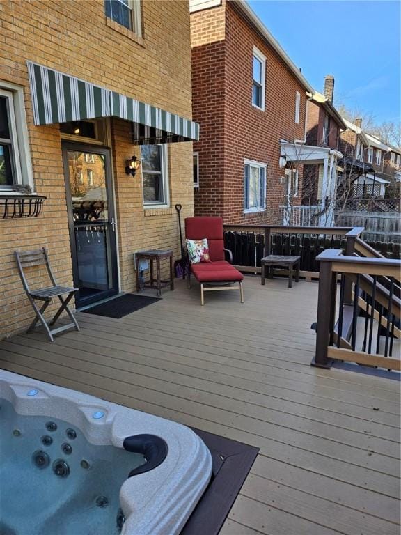 wooden deck with an outdoor hot tub