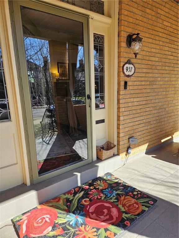 entrance to property with brick siding