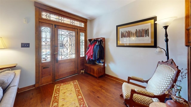 entryway with baseboards and wood finished floors