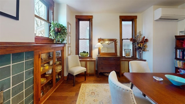 interior space featuring a wall unit AC and wood finished floors