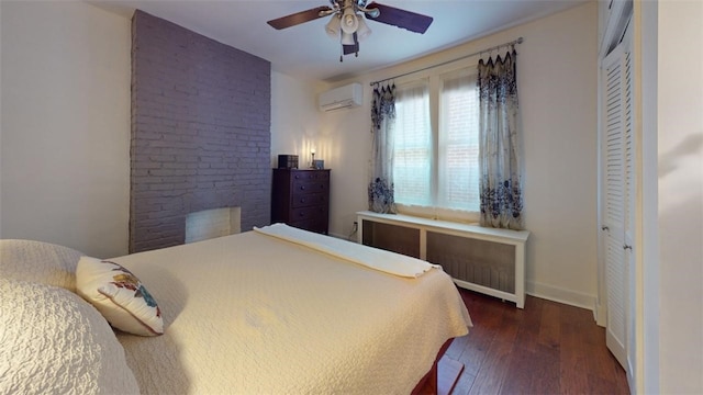 bedroom with a ceiling fan, hardwood / wood-style flooring, baseboards, and a wall mounted AC