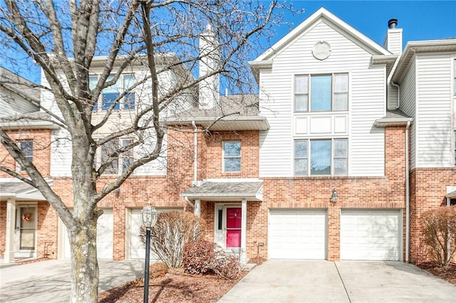 multi unit property featuring concrete driveway, brick siding, and an attached garage