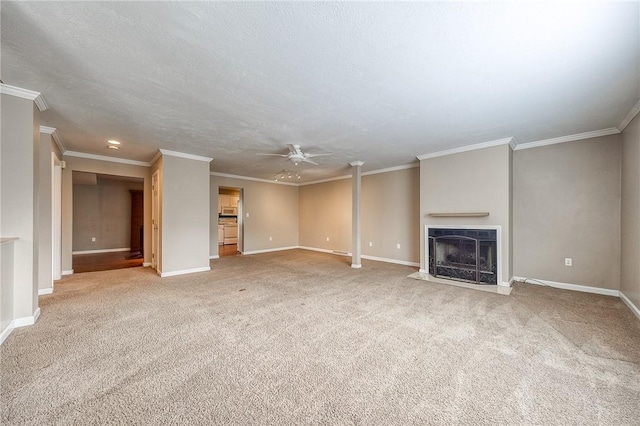 unfurnished living room featuring a fireplace with flush hearth, carpet flooring, baseboards, and a ceiling fan