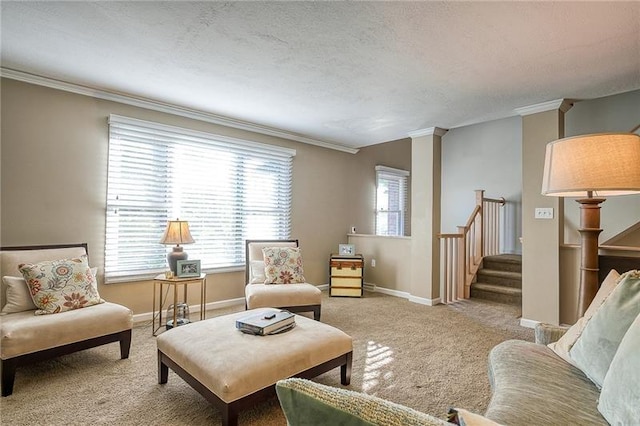 sitting room featuring stairs, baseboards, carpet flooring, and crown molding