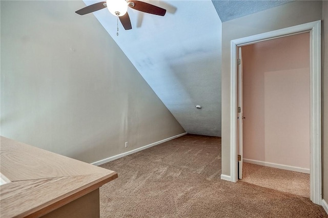 bonus room with carpet, a ceiling fan, and baseboards