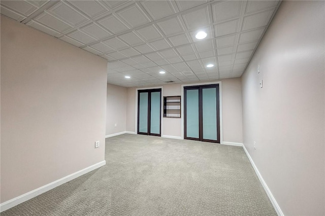 spare room with carpet floors, baseboards, french doors, and recessed lighting