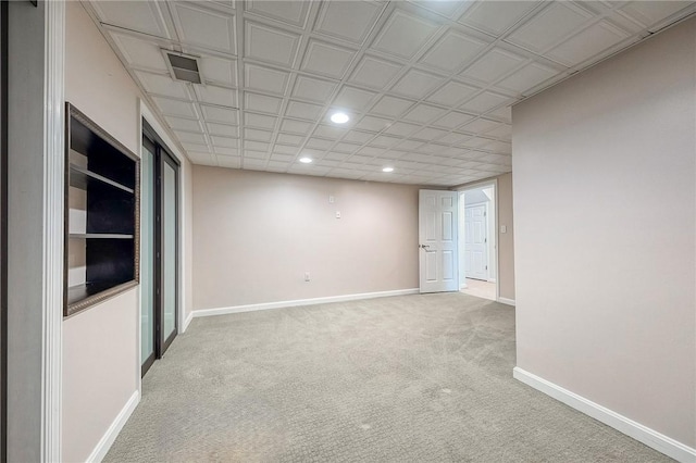 carpeted empty room with visible vents, baseboards, and recessed lighting