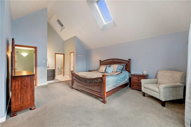 carpeted bedroom with high vaulted ceiling, a skylight, connected bathroom, and baseboards