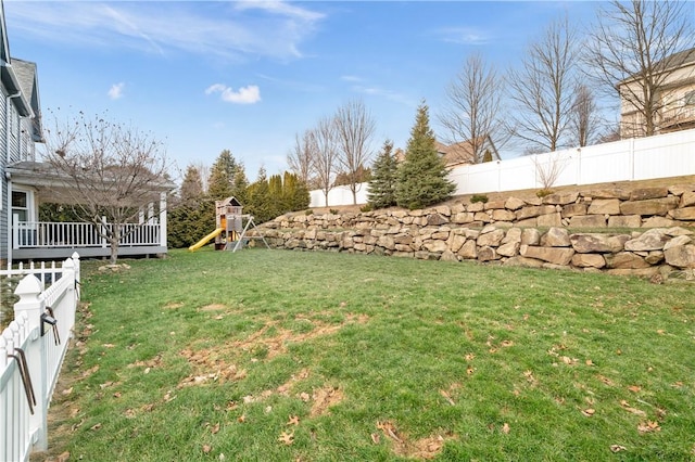 view of yard featuring a fenced backyard and a playground