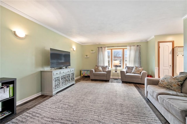 living area with ornamental molding, wood finished floors, and baseboards