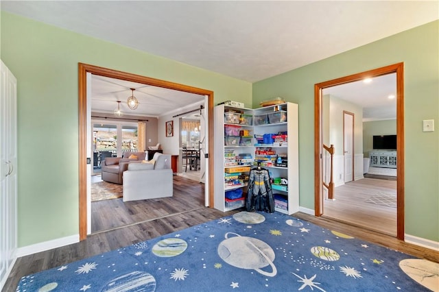 bedroom with wood finished floors and baseboards