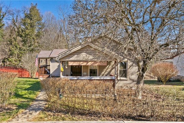 view of front of property with a porch and a front lawn