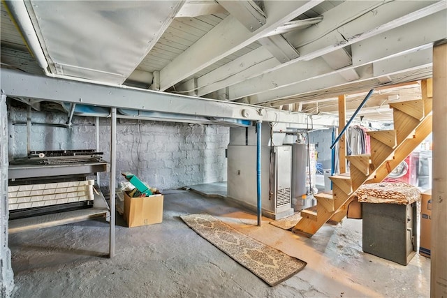 unfinished below grade area featuring water heater and stairs