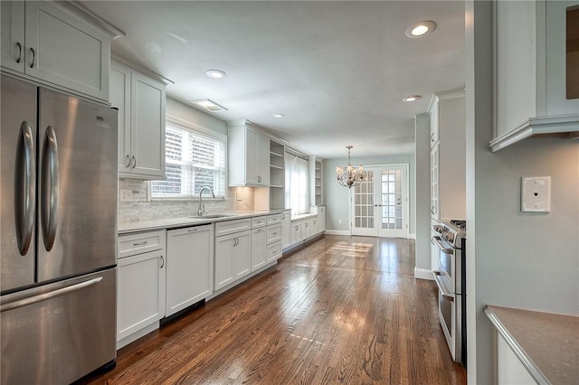 kitchen featuring baseboards, decorative backsplash, appliances with stainless steel finishes, dark wood-style flooring, and open shelves