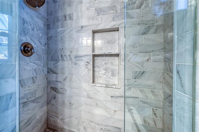 bathroom with tiled shower