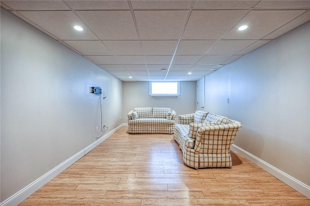 unfurnished room with light wood-type flooring, a paneled ceiling, baseboards, and recessed lighting