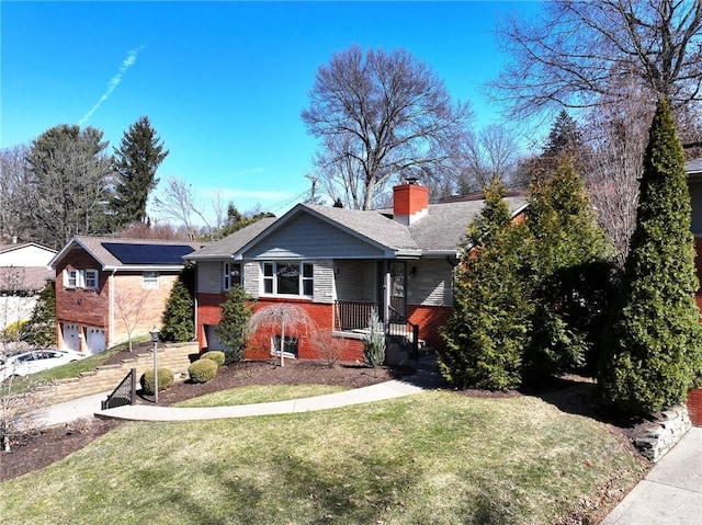 ranch-style home with driveway, brick siding, a chimney, and a front yard