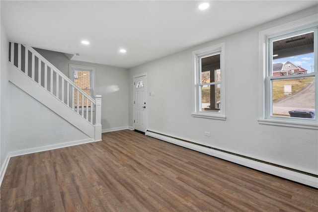 entrance foyer with stairs, baseboards, baseboard heating, and wood finished floors