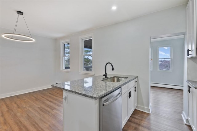 kitchen featuring light stone counters, a baseboard radiator, a sink, white cabinetry, and stainless steel dishwasher