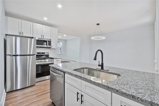 kitchen with white cabinetry, appliances with stainless steel finishes, and a sink