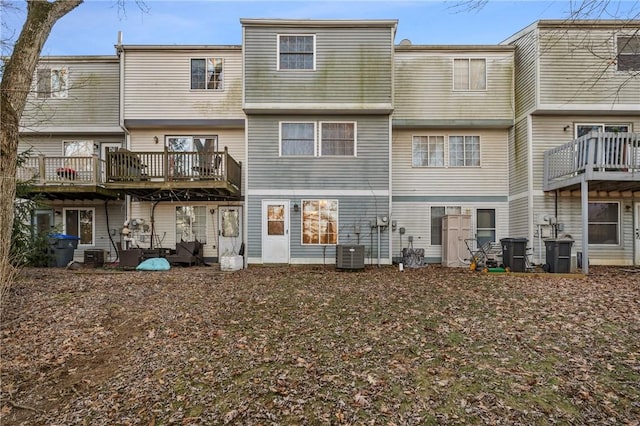 back of house with a deck and central AC unit