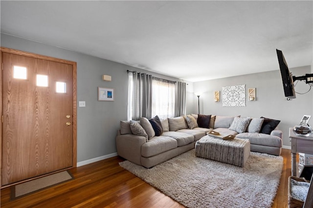 living room with baseboards and wood finished floors