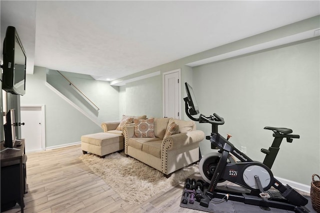 exercise room featuring baseboards and wood finished floors