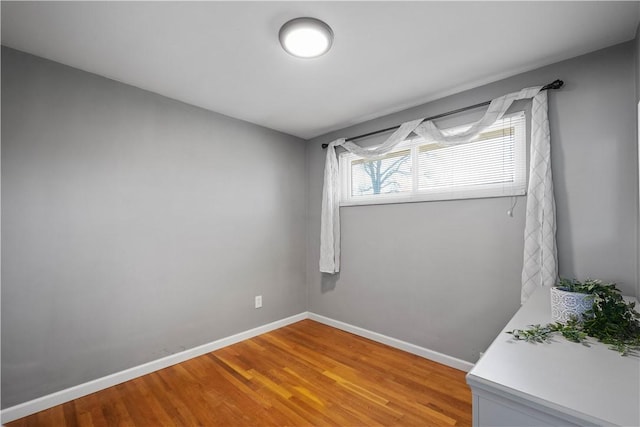 spare room with light wood finished floors and baseboards