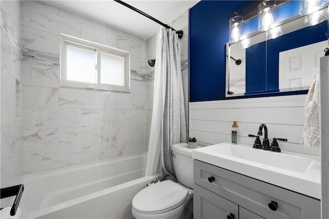 bathroom featuring toilet, shower / tub combo with curtain, and vanity