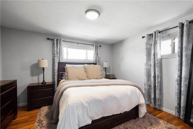 bedroom featuring baseboards and wood finished floors