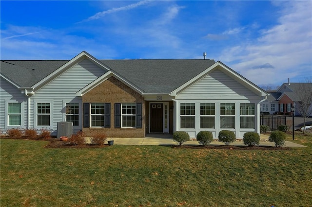 ranch-style home with a patio, fence, central AC, a front lawn, and brick siding