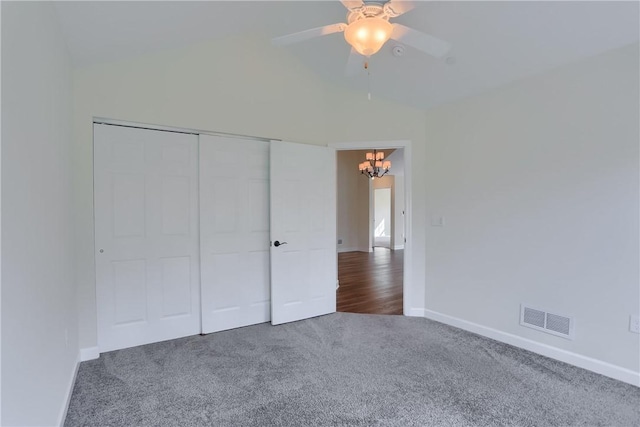 unfurnished bedroom with visible vents, carpet flooring, baseboards, and lofted ceiling