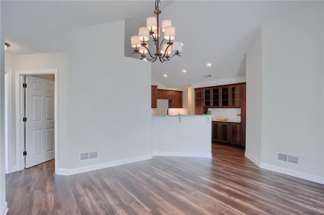 unfurnished living room with visible vents, baseboards, and wood finished floors