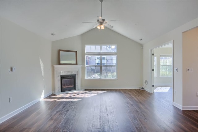 unfurnished living room with a premium fireplace, baseboards, and dark wood-type flooring