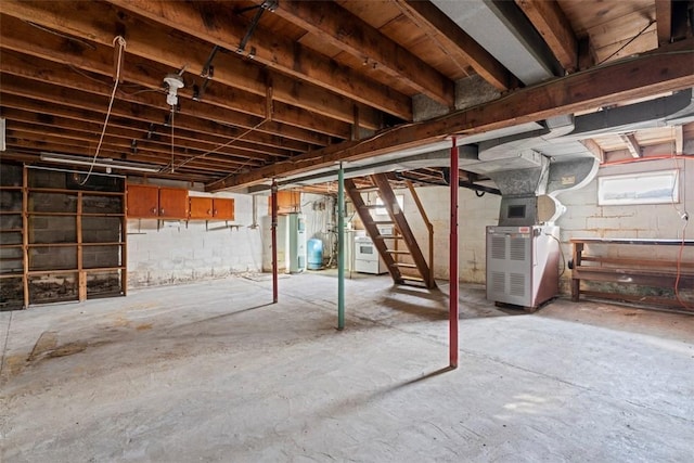 below grade area featuring washer / dryer, water heater, stairway, and heating unit