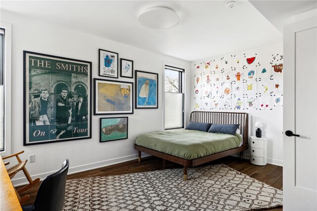 bedroom featuring baseboards and wood finished floors