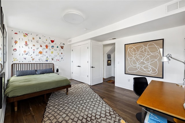 bedroom with visible vents, dark wood finished floors, and baseboards