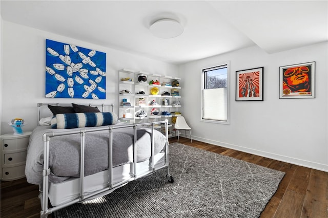 bedroom featuring hardwood / wood-style flooring and baseboards